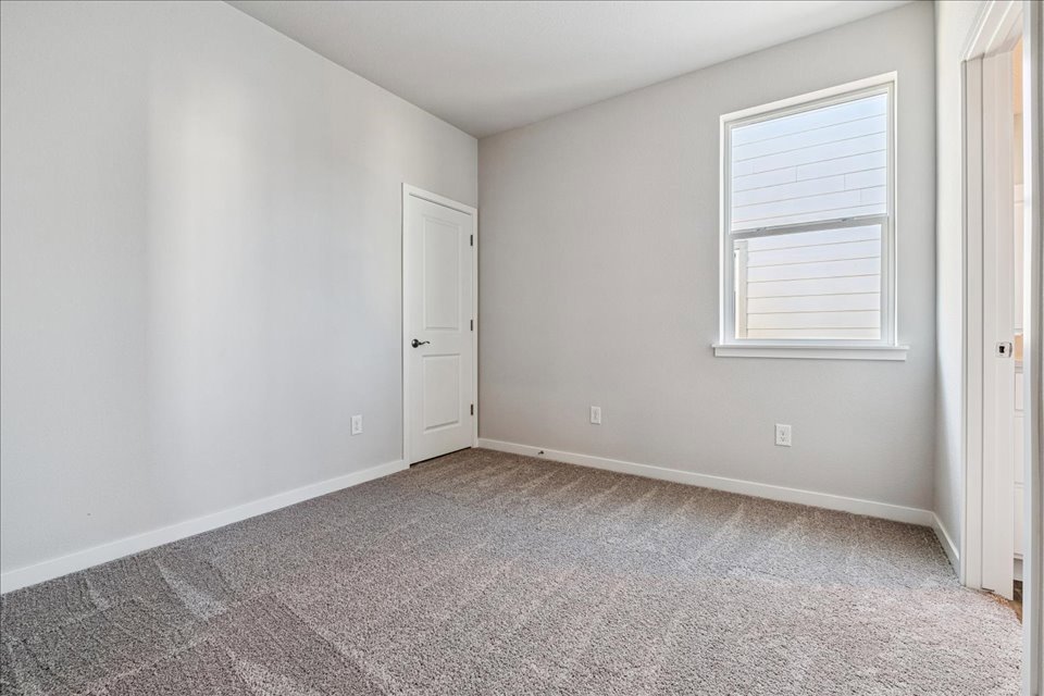 A room with white walls and a door.