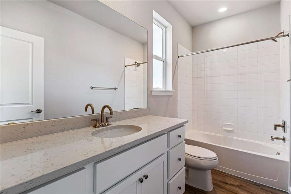 A bathroom with a sink toilet and bathtub.