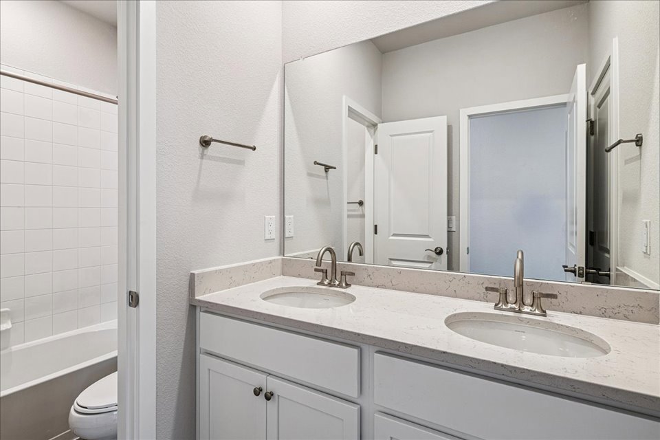 A bathroom with a sink and a toilet.