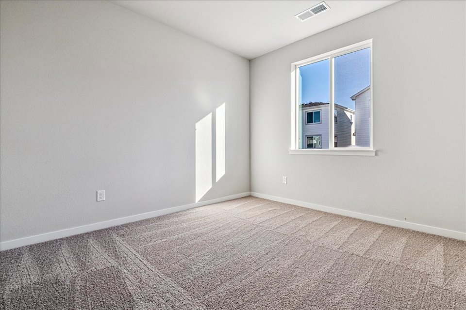 A room with a window and carpet.