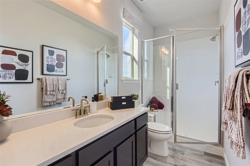 A bathroom with a sink toilet and shower.