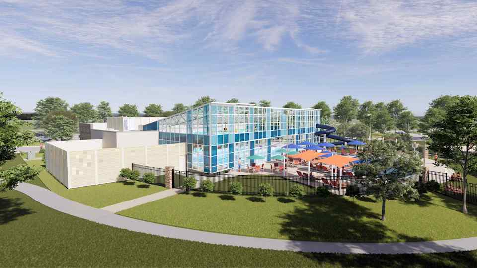 A building with a lawn and trees.