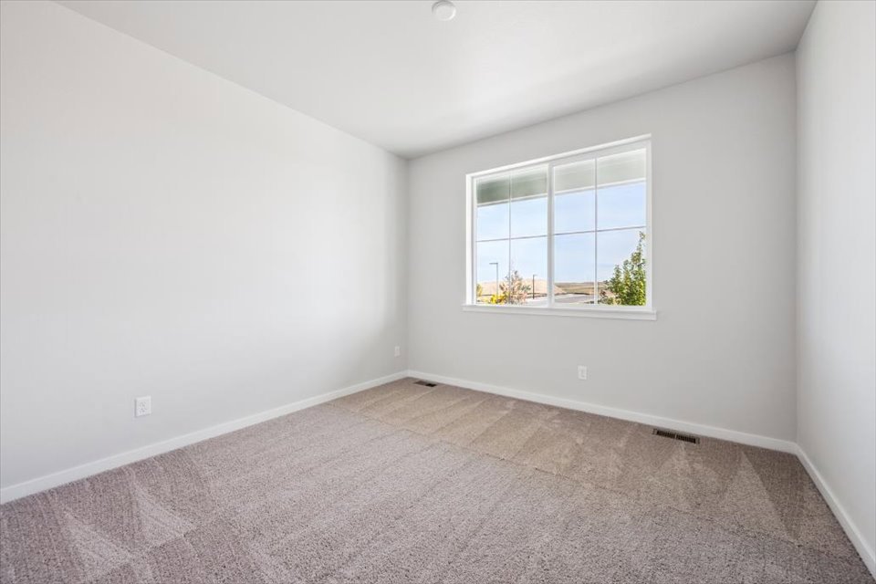 A room with a window and a carpet.