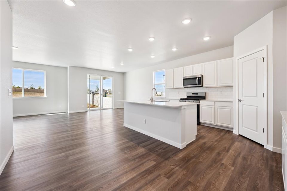 A large kitchen with white cabinets.