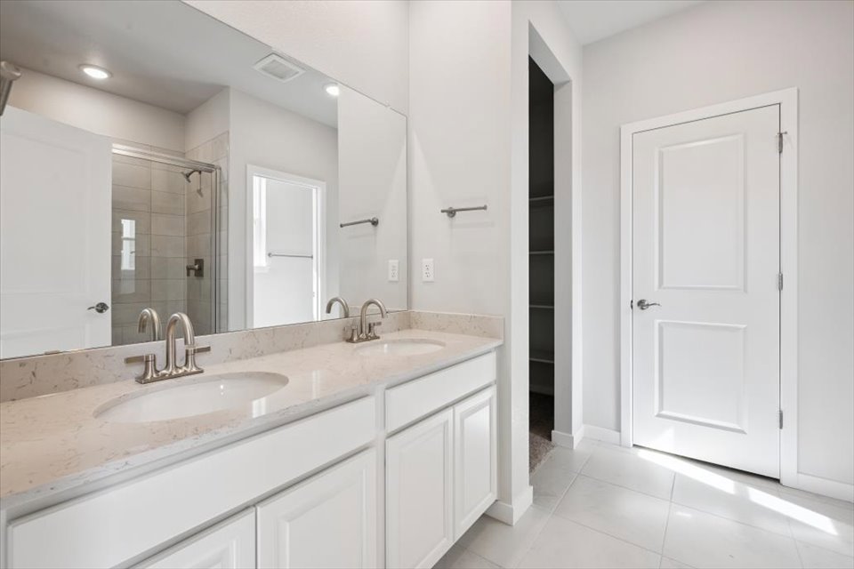 A bathroom with a large mirror.