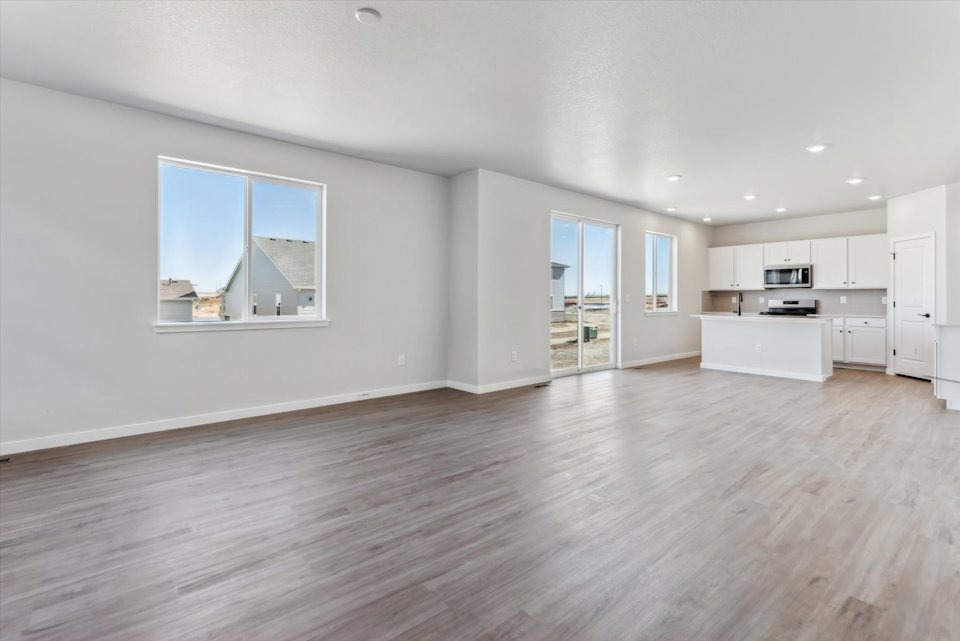 A large empty room with white cabinets.