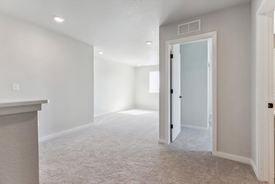 A hallway with white walls.