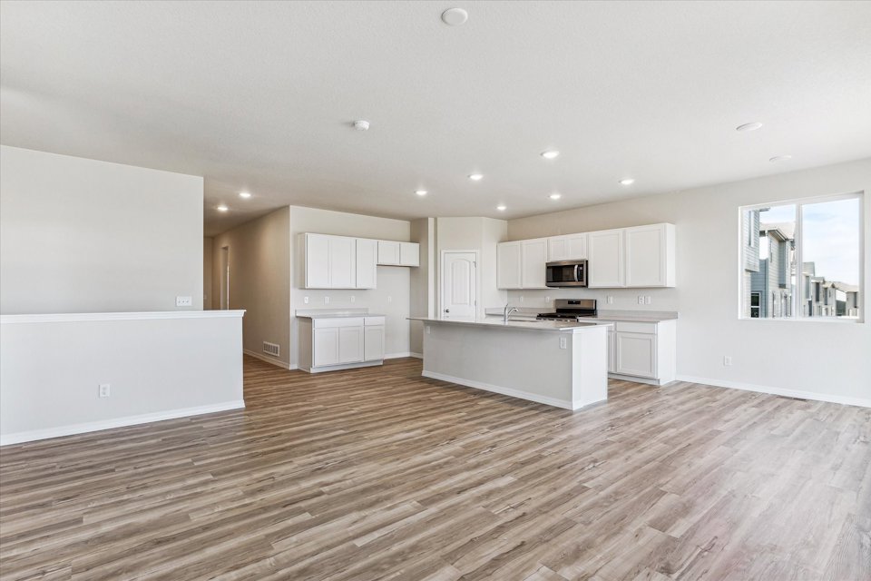 A large kitchen with white cabinets.