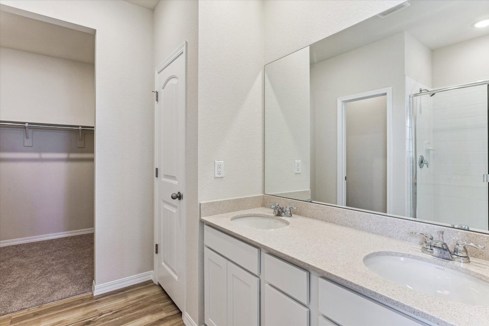 A bathroom with a large mirror.