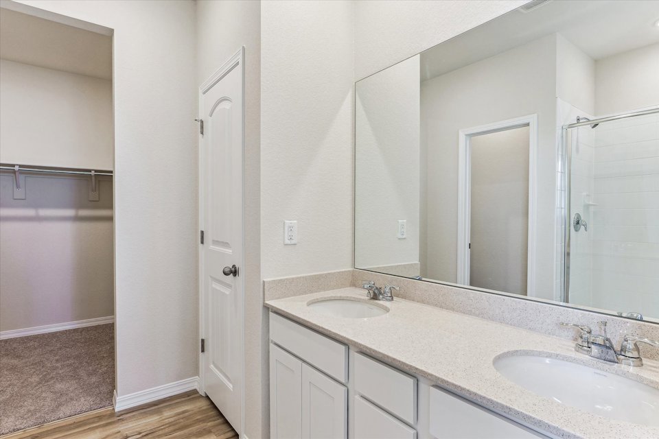 A bathroom with a large mirror.