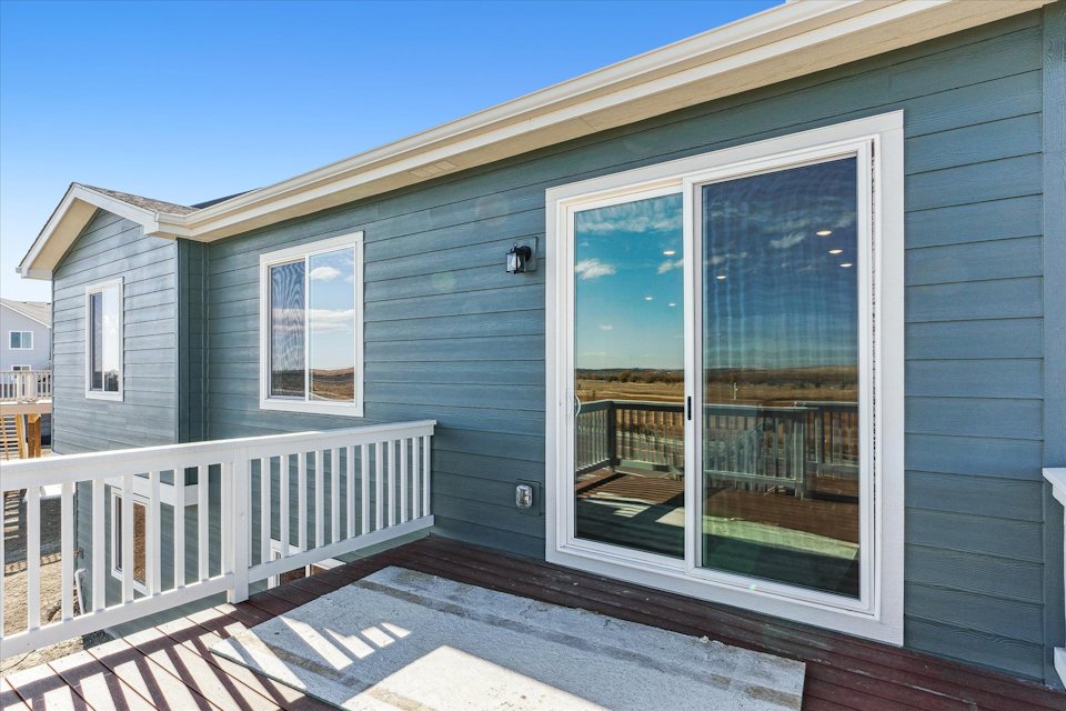 A house with a deck and a white railing.
