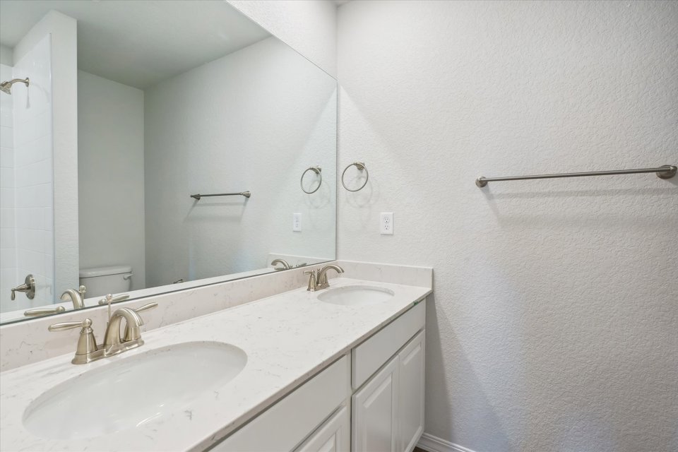 A bathroom with a large mirror.