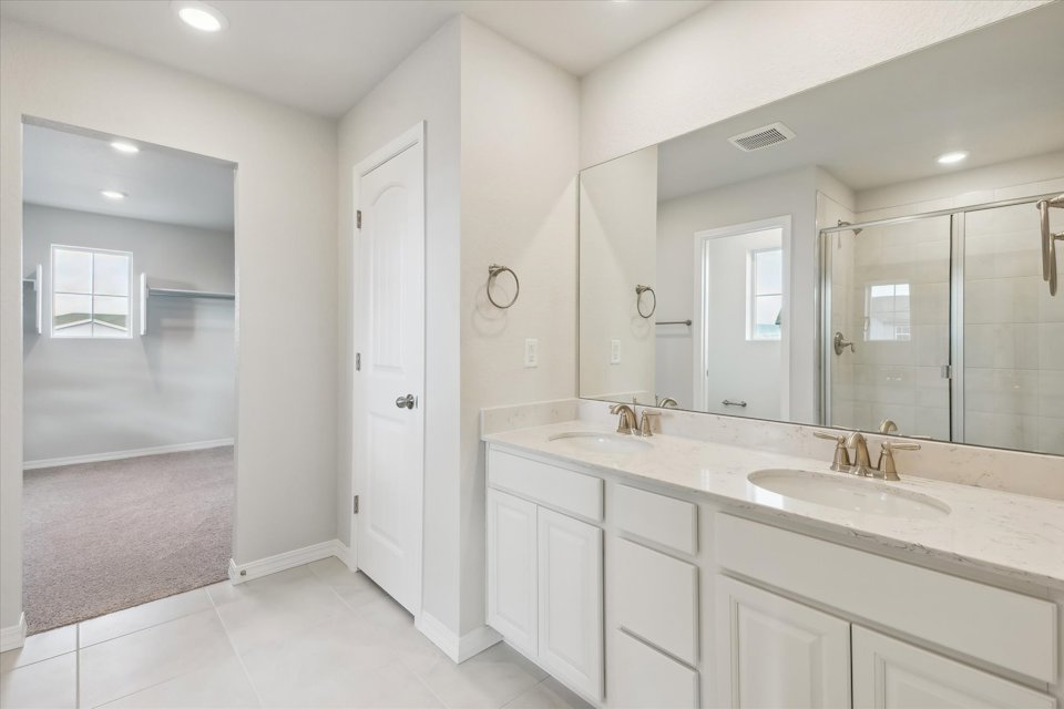 A bathroom with a large mirror.