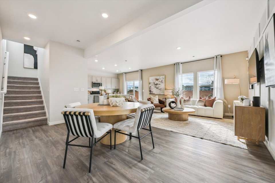 A large living room with a dining table and chairs.