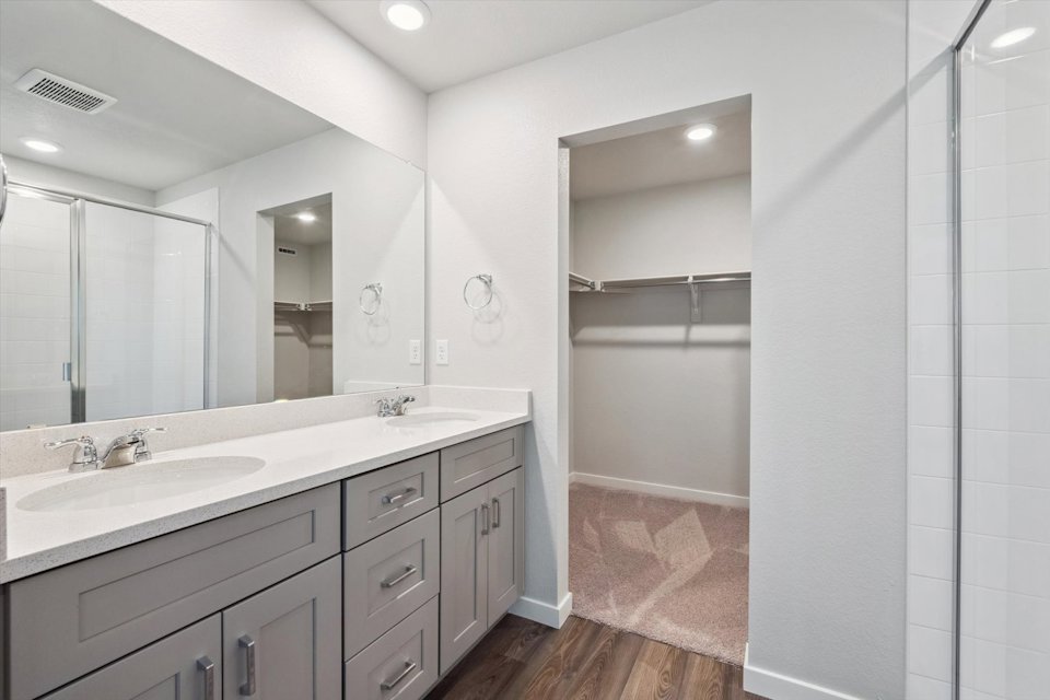 A bathroom with a shower unit and sink.
