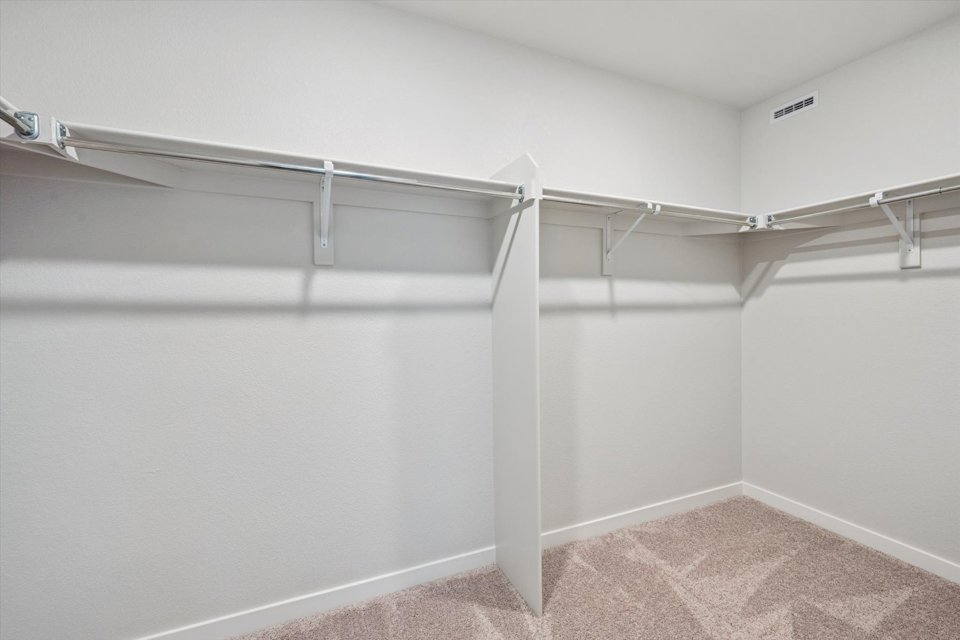 A white wall with a metal railing.