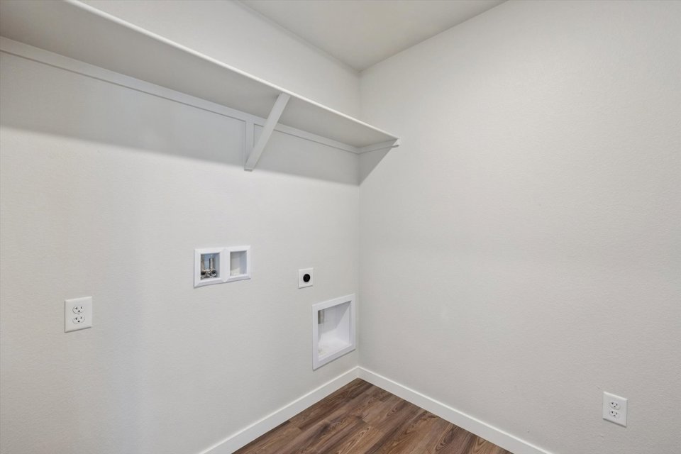 A white room with a wood floor and a wood floor.