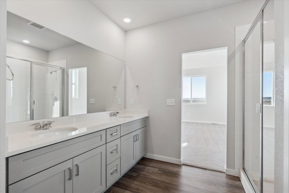A bathroom with a large mirror.