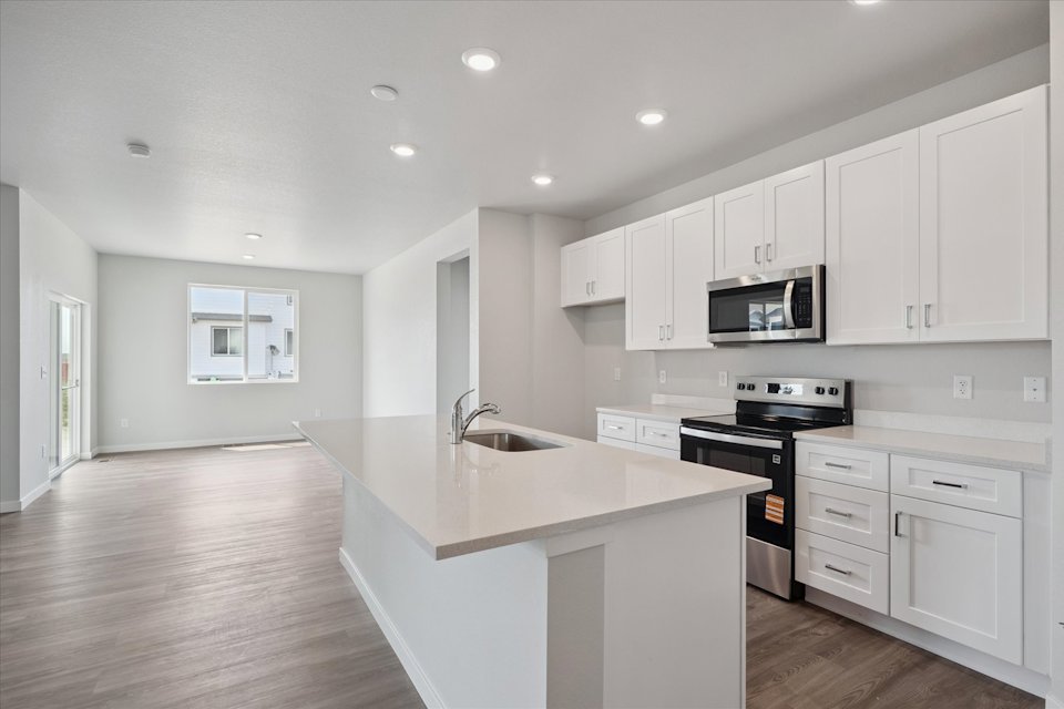 A kitchen with white cabinets.
