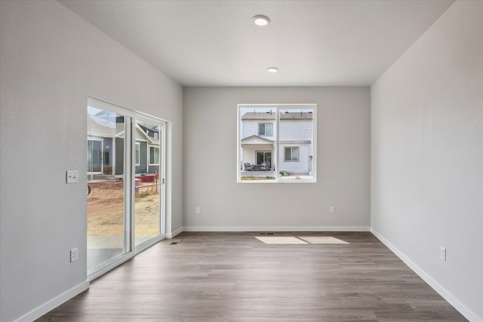 A room with a glass door and a wood floor.