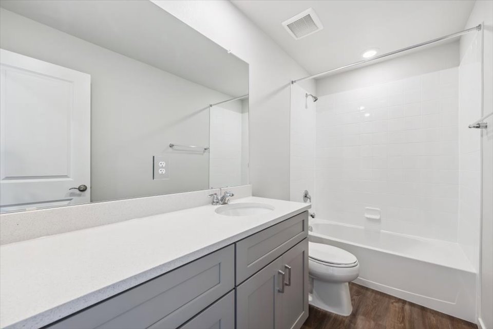 A bathroom with a tub sink and toilet.