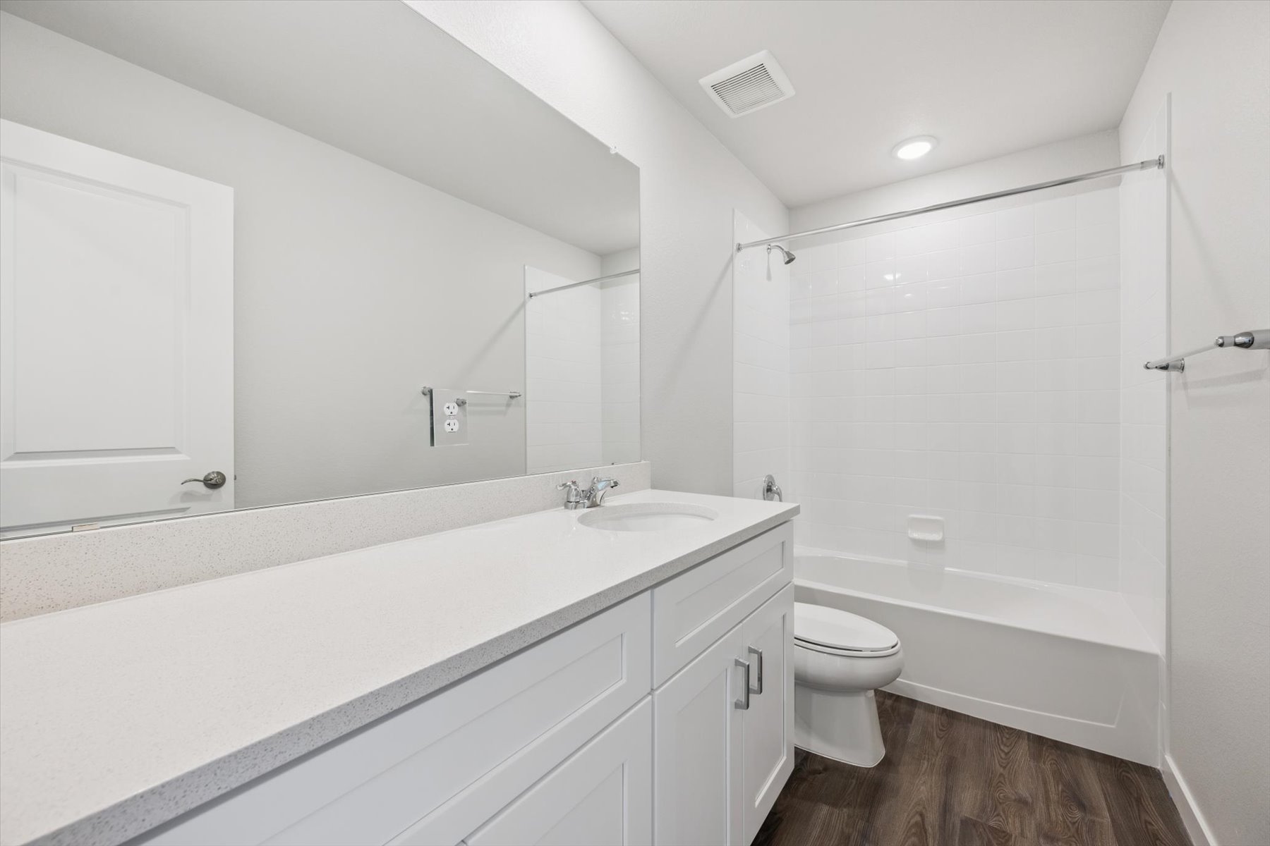A bathroom with a tub toilet and sink.