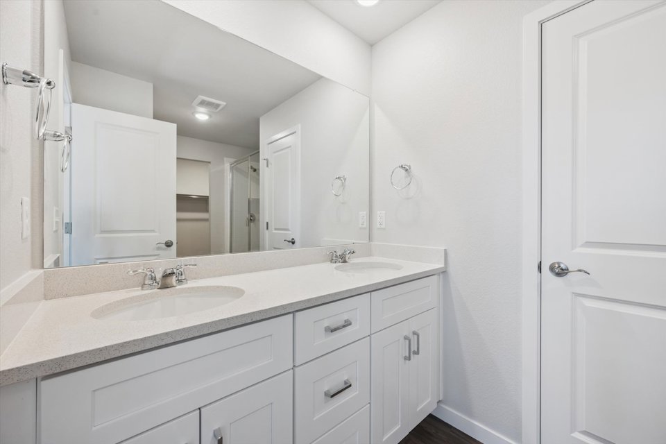 A bathroom with a large mirror.