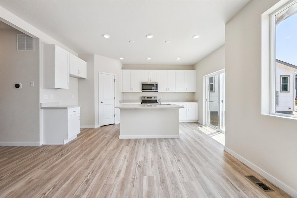 A large kitchen with white cabinets.
