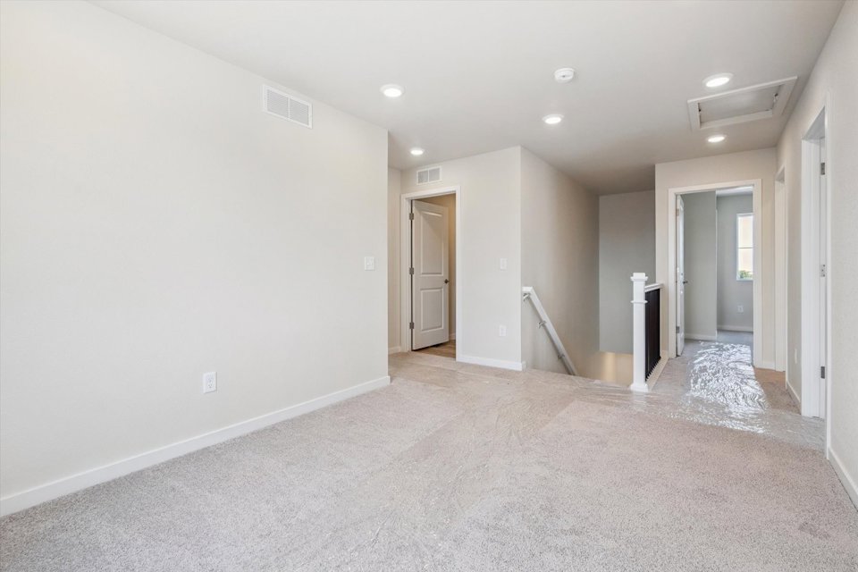 A long hallway with white walls.