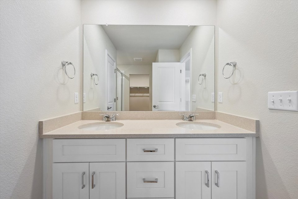 A bathroom with a large mirror.