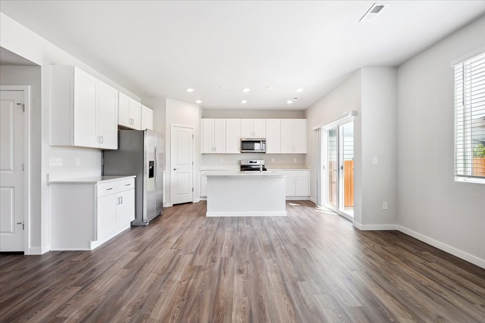 A kitchen with white cabinets.
