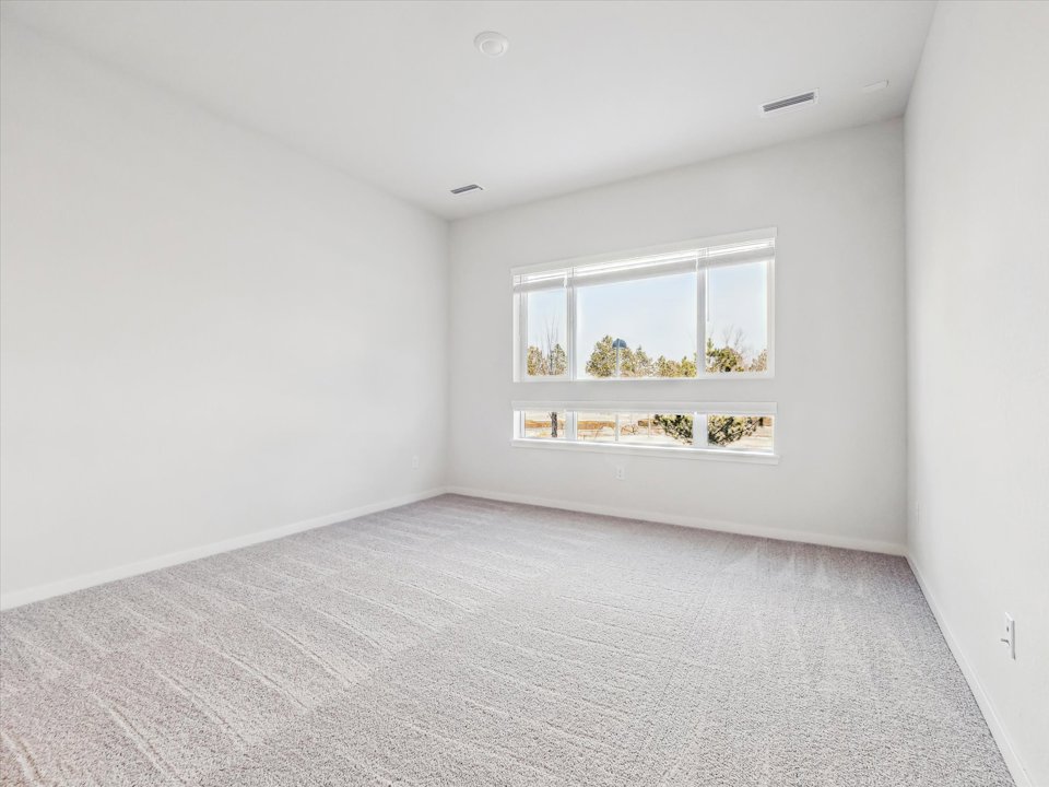 A room with a window and a carpet.