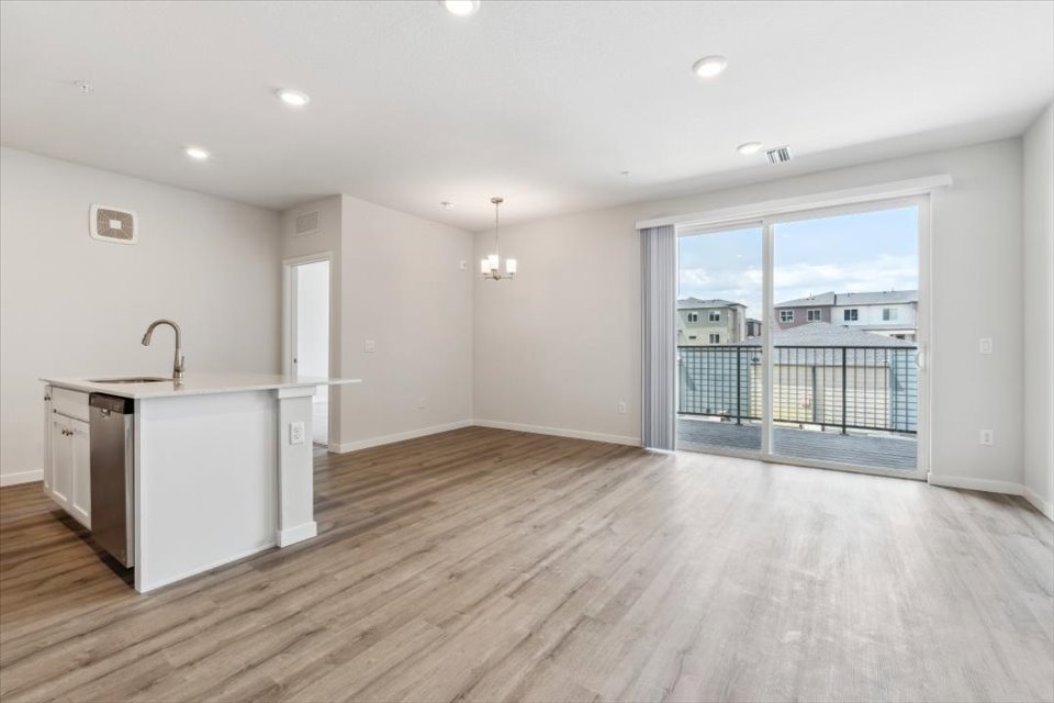 A kitchen with a wood floor.
