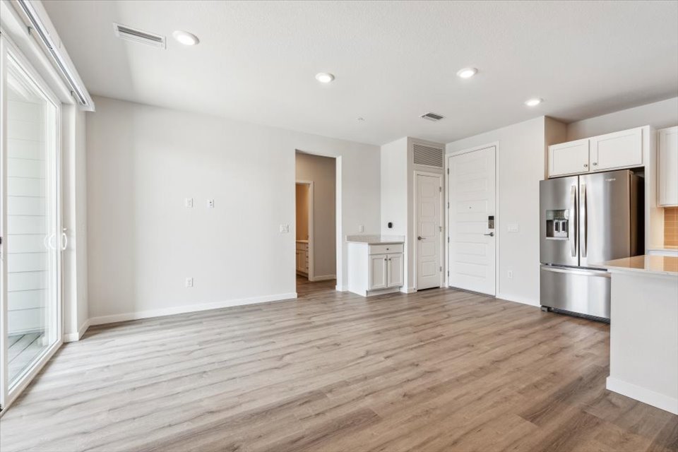 A kitchen with white cabinets.