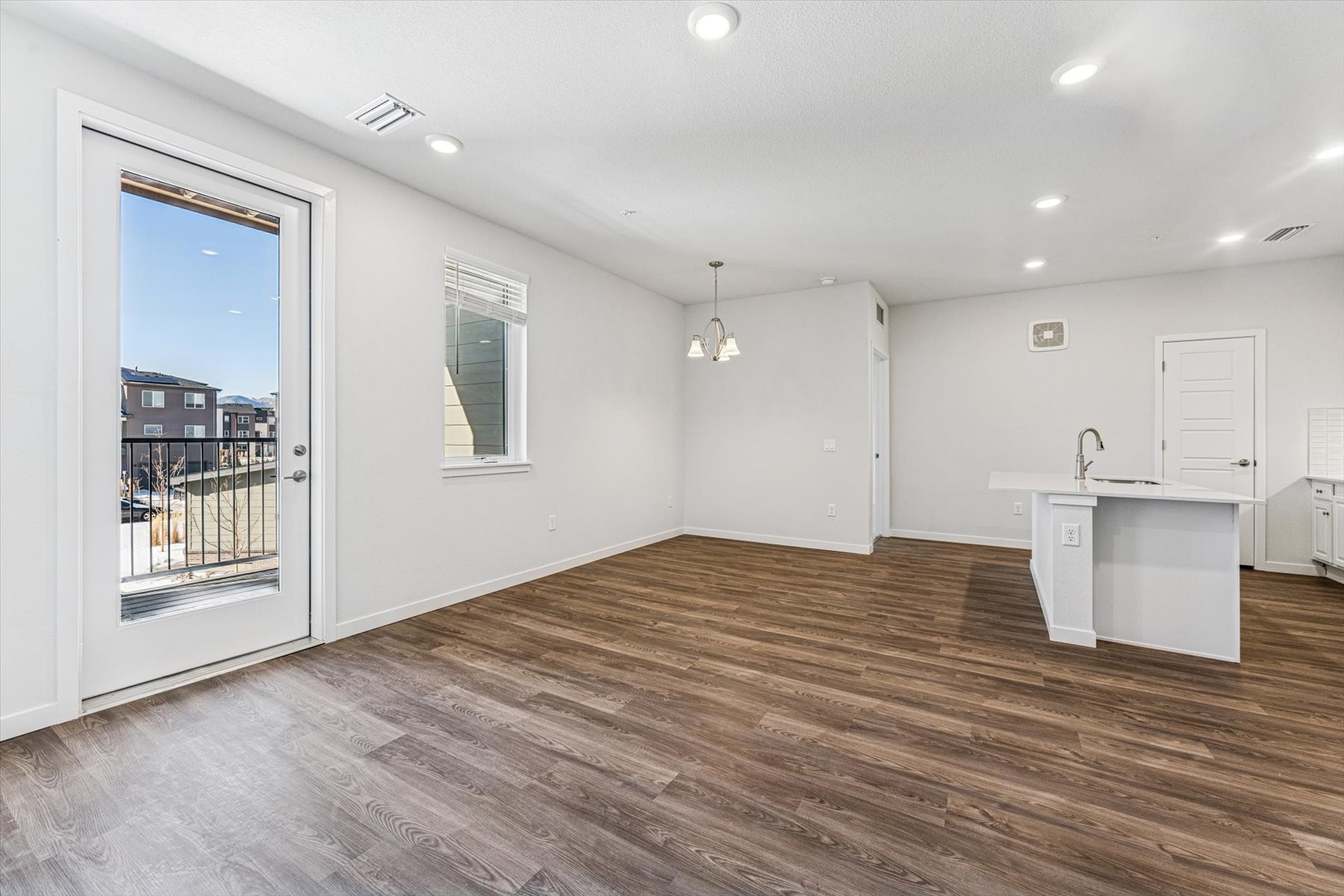 A large empty room with a wood floor and a wood floor.