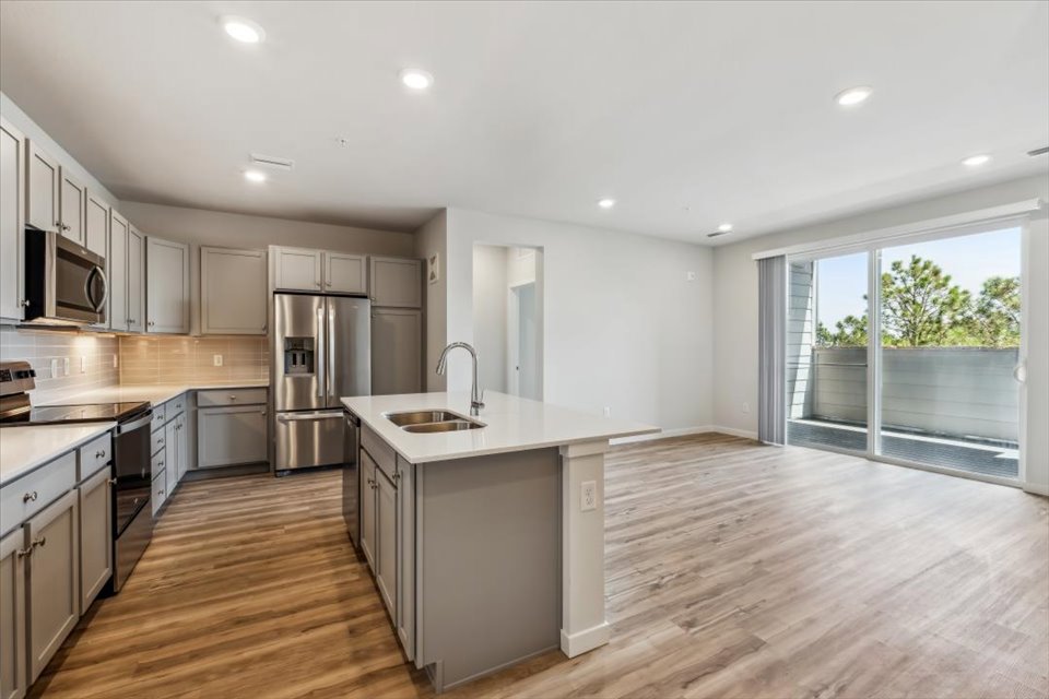 A kitchen with wooden floors.