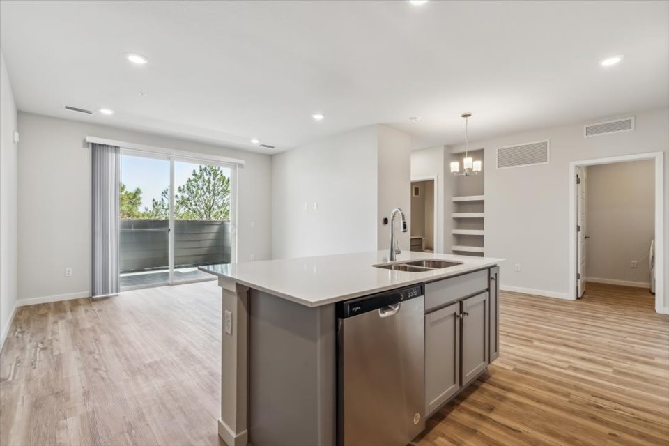 A kitchen with a wood floor.