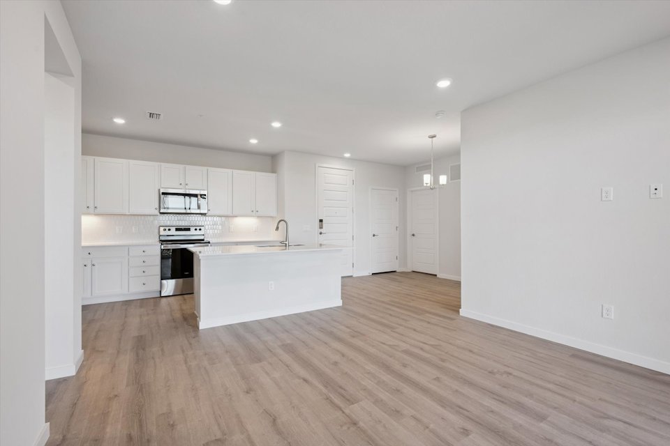 A kitchen with white cabinets.