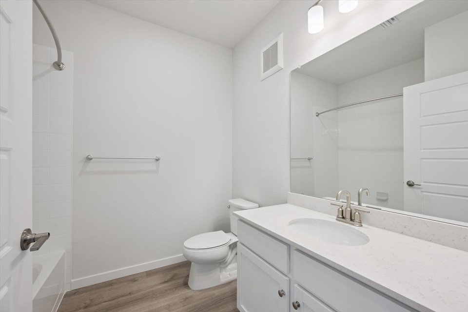A bathroom with a sink toilet and shower.