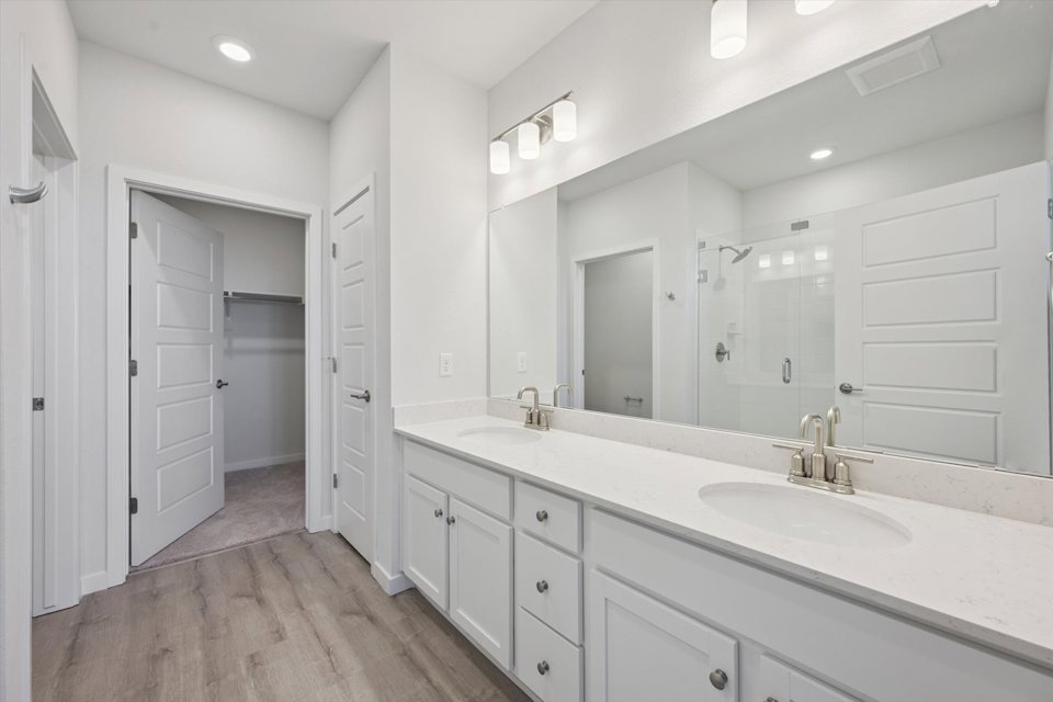 A bathroom with white cabinets.