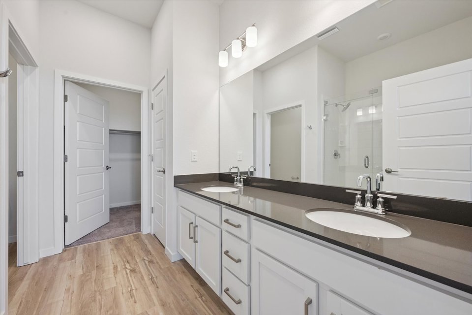 A bathroom with a large mirror.