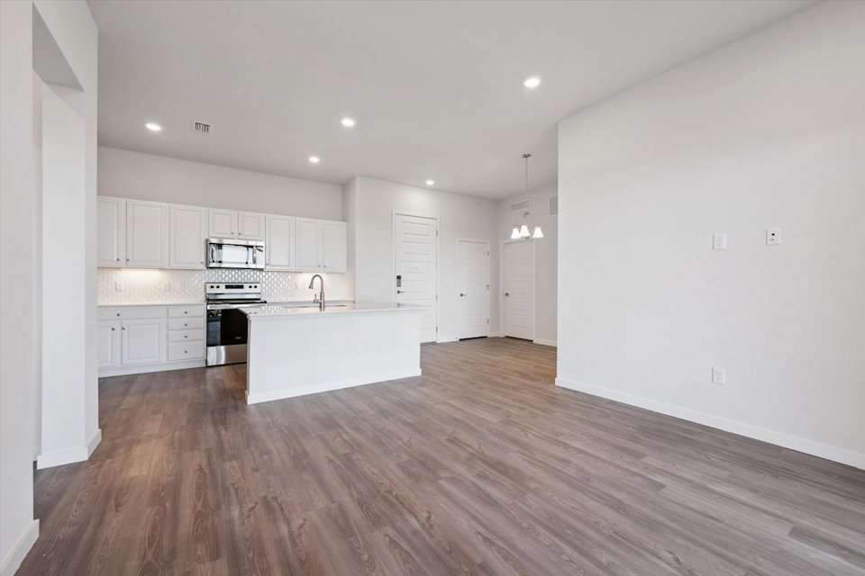 A kitchen with white cabinets.