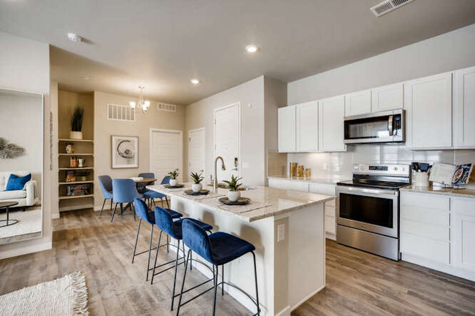 A kitchen with white cabinets.