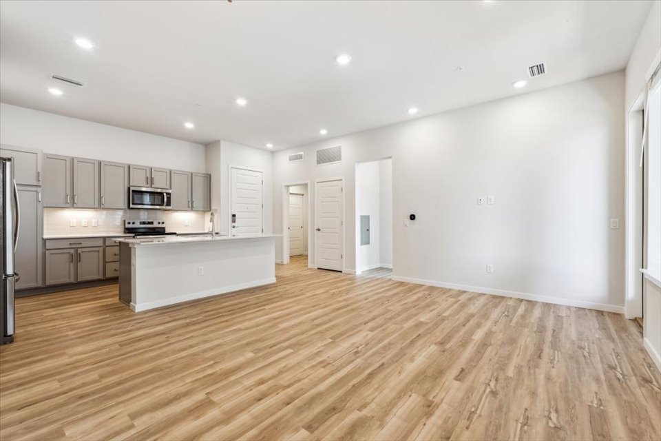 A kitchen with white cabinets.