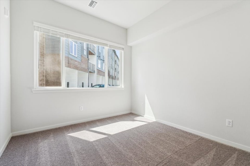 A room with a window and a tile floor.