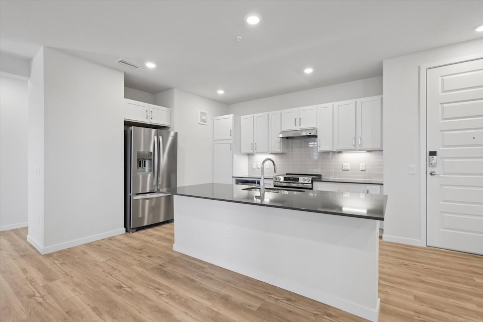 A kitchen with white cabinets.