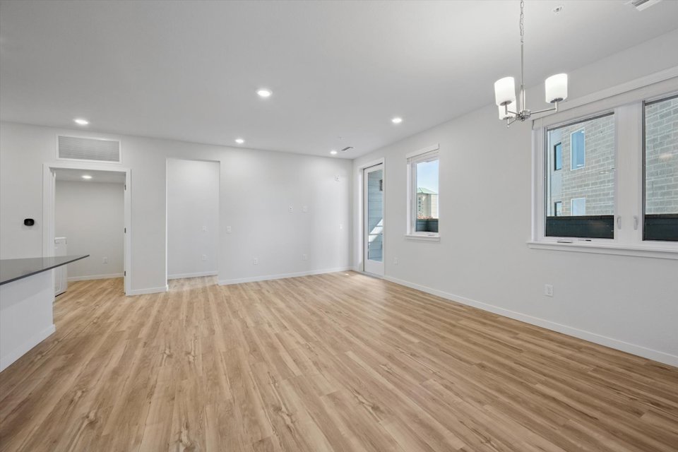 A room with a wood floor and white walls.