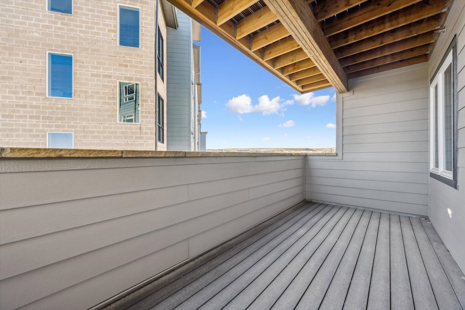 A wooden deck next to a building.