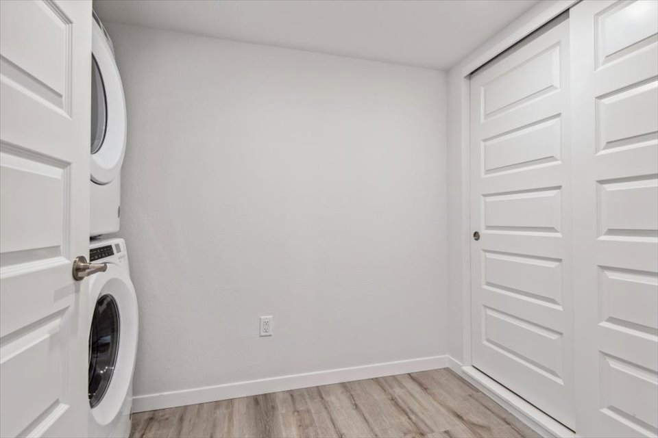 A white room with a washing machine.