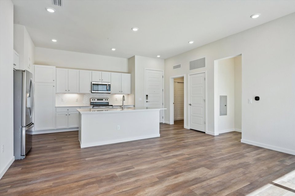 A kitchen with white cabinets.